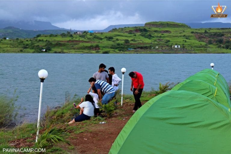 group of tent sitting near lake
