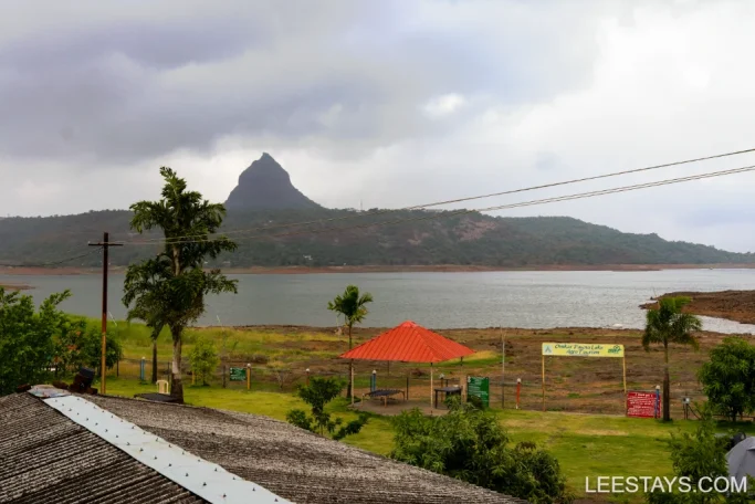 View of Pawna Lake with a scenic backdrop of hills, near lakeview cottages and resort accommodations.