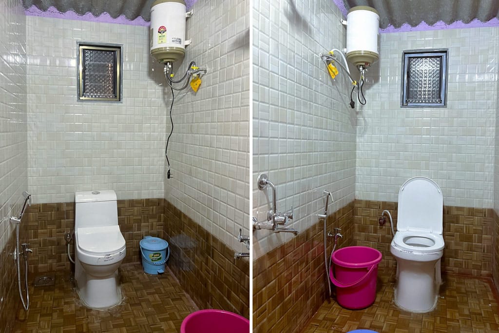 Interior view of a restroom featuring a toilet, washbasin, and water heater on the wall.